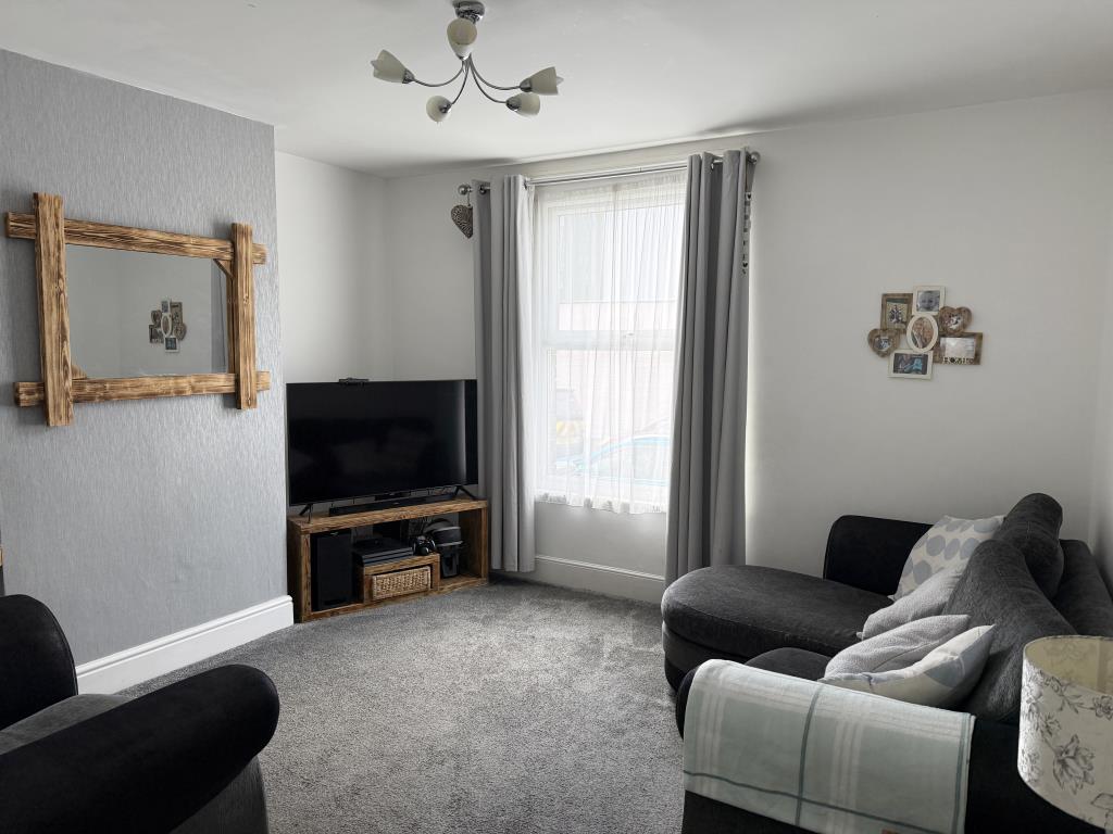 Lot: 108 - THREE-BEDROOM THREE STOREY HOUSE FOR INVESTMENT - Living room with grey carpet and painted walls